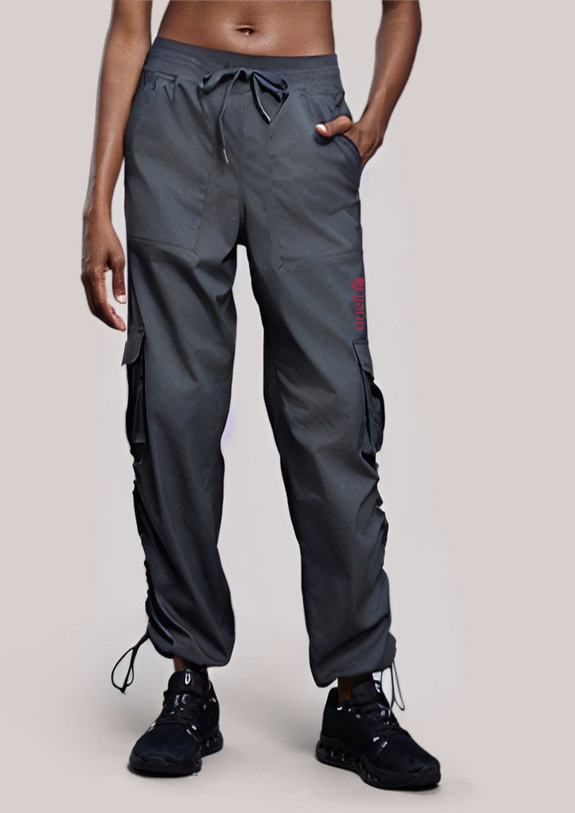 Woman wearing ARIELL grey charcoal water-resistant cargo pants with multiple pockets