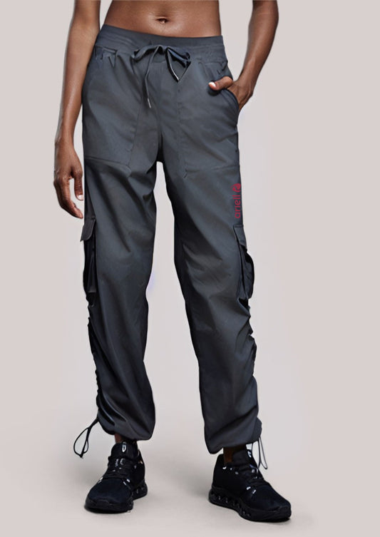 Woman wearing ARIELL grey charcoal water-resistant cargo pants with multiple pockets