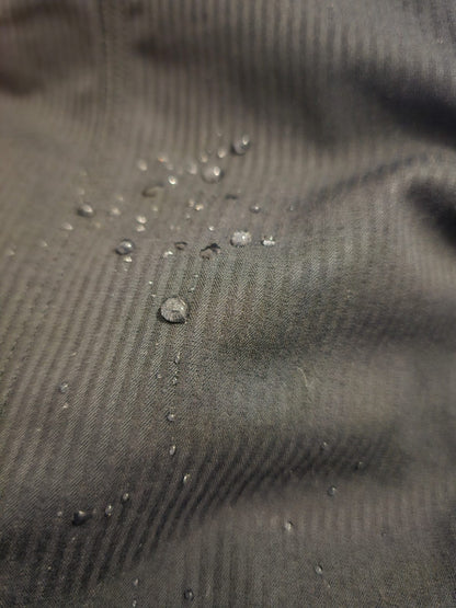 Close-up of a textured Charcoal fabric with water droplets on it